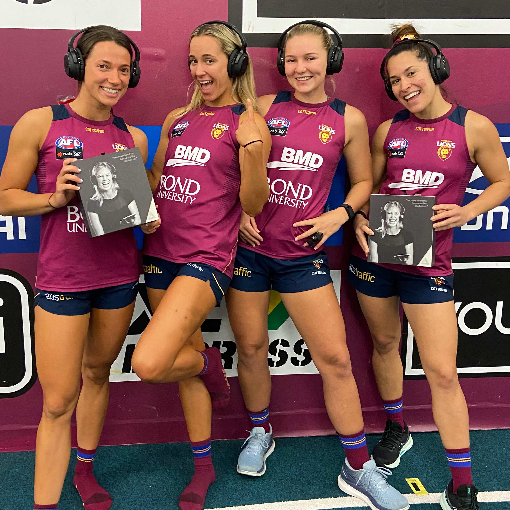 Brisbane Lions AFLW players wearing their Audeara headphones