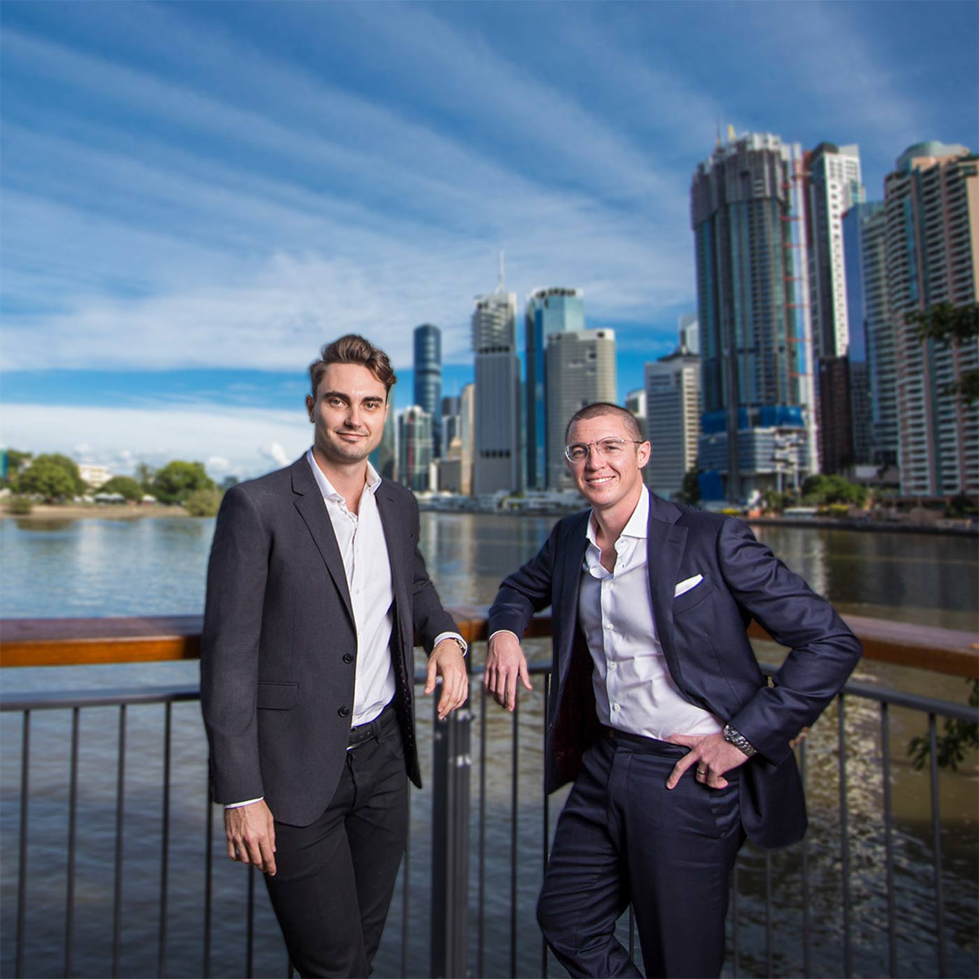 Audeara founders, Alex Afflick and Dr. James Fielding standing in front of the Brisbane River and cityscape