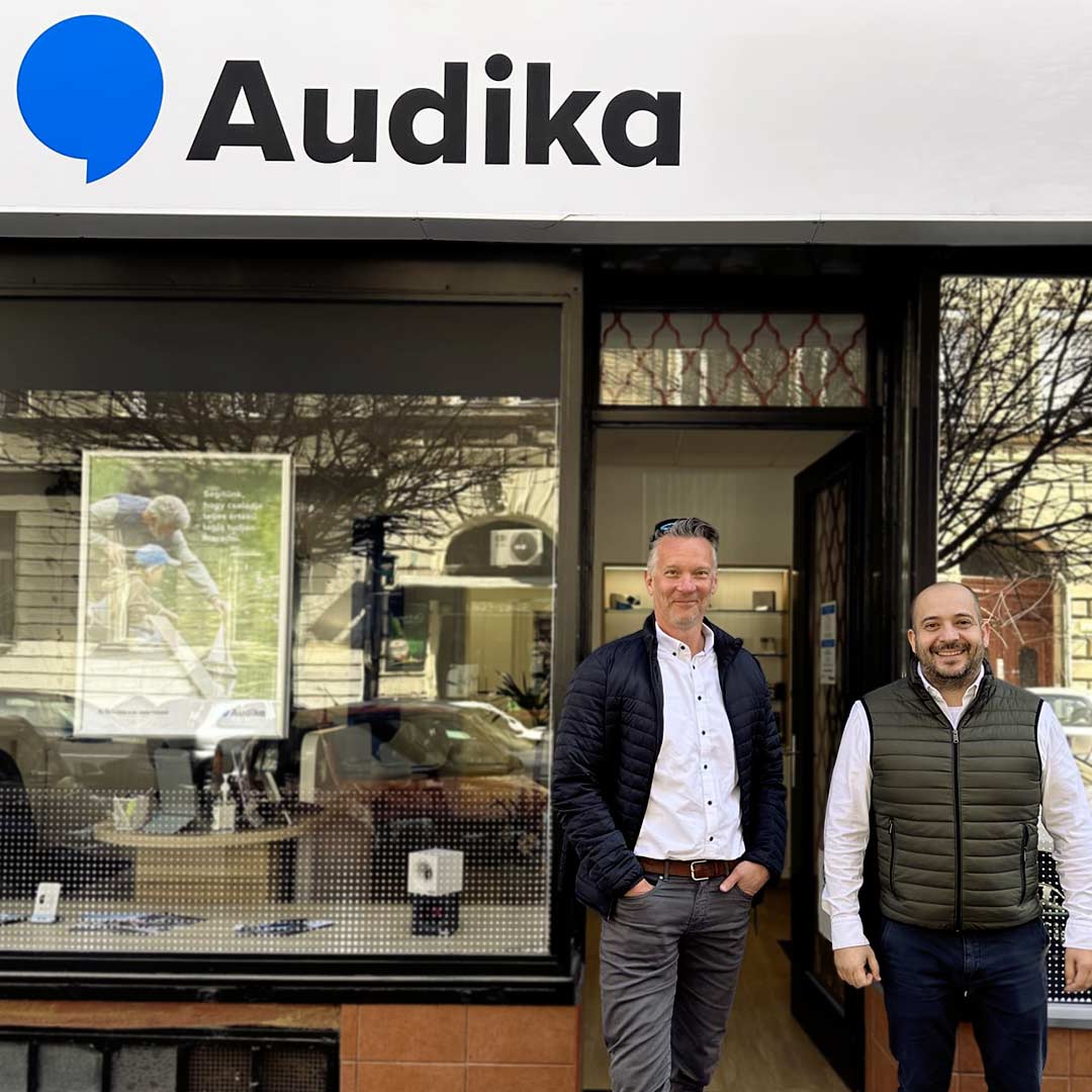 Istvan Nagy and Szabolcs Spiczmüller standing in front of an Audika store in Hungary